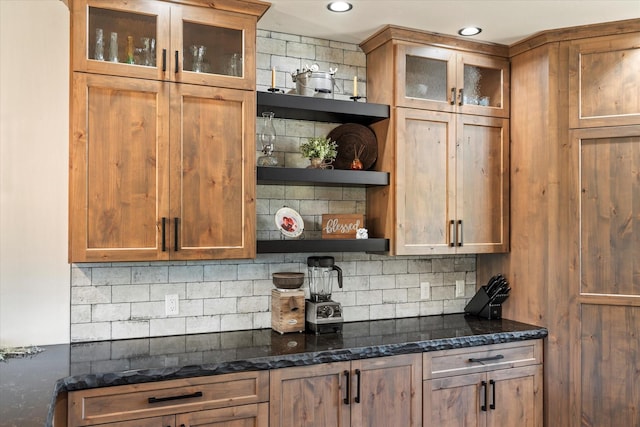 bar with backsplash and dark stone counters