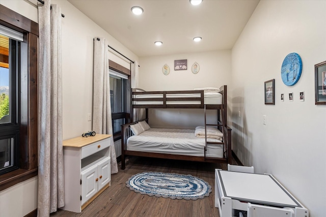 bedroom with dark hardwood / wood-style floors