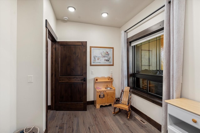 corridor featuring dark hardwood / wood-style floors