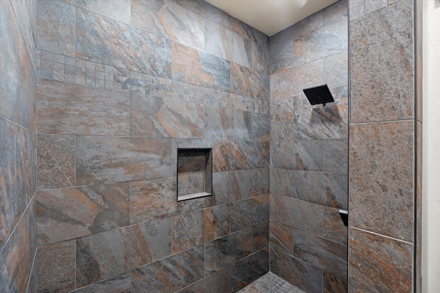 bathroom with tiled shower