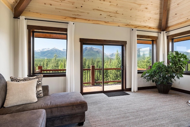 doorway to outside with a mountain view, carpet, lofted ceiling with beams, and wood ceiling