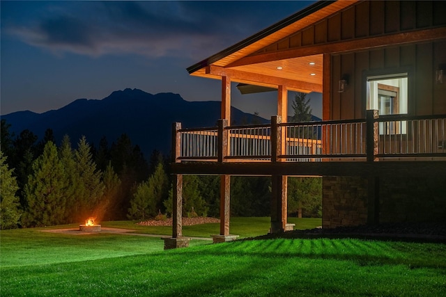 exterior space featuring a mountain view and a fire pit