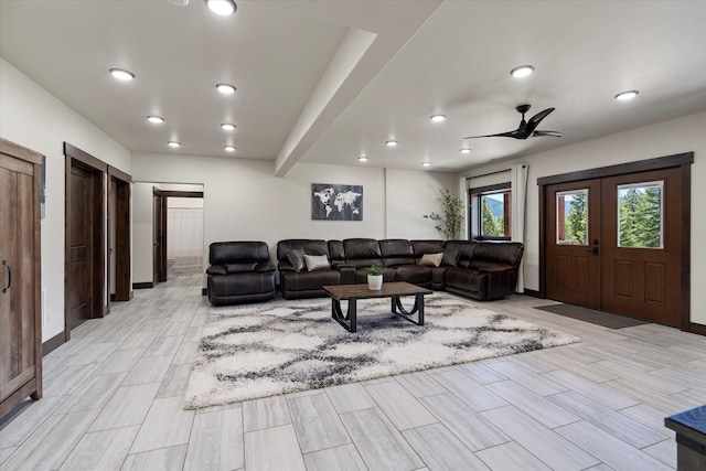 living room featuring ceiling fan and french doors