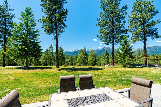 view of yard featuring a patio area and a mountain view