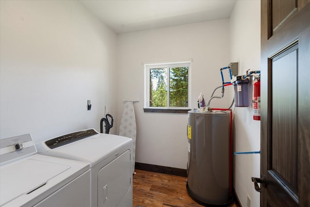 laundry room with washer and dryer, electric water heater, and dark hardwood / wood-style floors