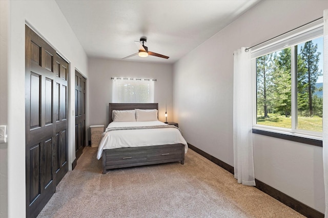 carpeted bedroom with ceiling fan