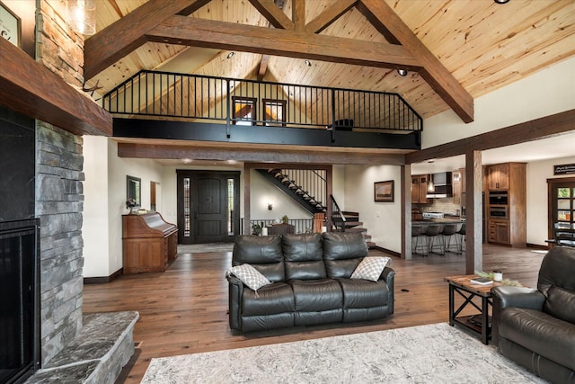 living room with hardwood / wood-style floors, a stone fireplace, high vaulted ceiling, wooden ceiling, and beam ceiling