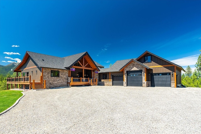 view of front of house featuring a wooden deck, a garage, and covered porch