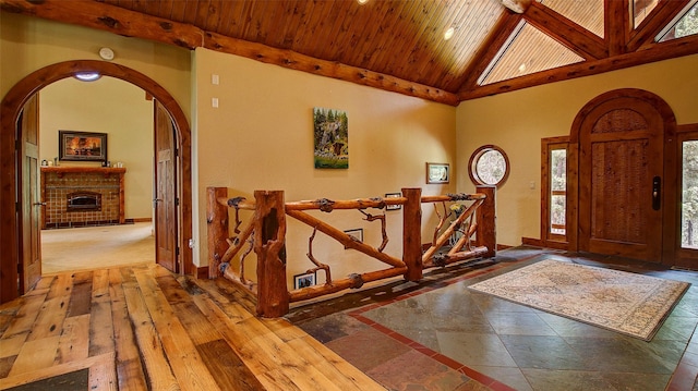 foyer with high vaulted ceiling and wood ceiling