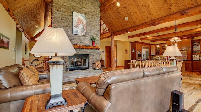 living room featuring wooden ceiling, a high ceiling, light hardwood / wood-style flooring, a fireplace, and beam ceiling