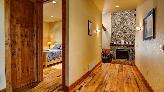 hallway with hardwood / wood-style flooring