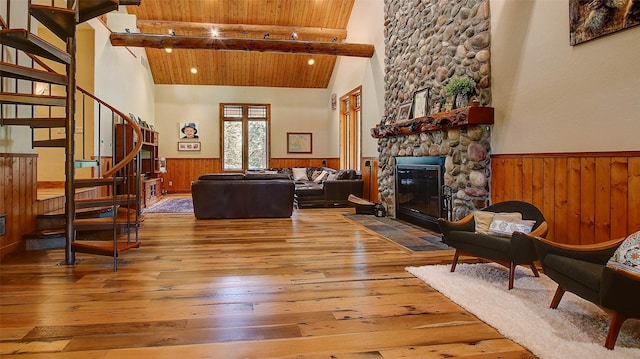 living room with a fireplace, lofted ceiling with beams, hardwood / wood-style flooring, and wooden ceiling