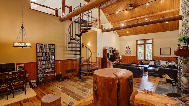 living room featuring wooden ceiling, high vaulted ceiling, beamed ceiling, wood-type flooring, and a chandelier