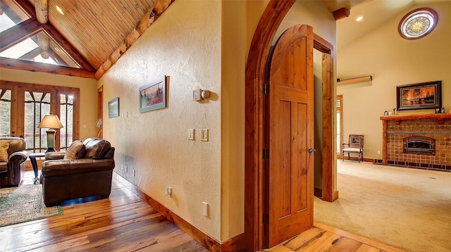 corridor with wood-type flooring, high vaulted ceiling, french doors, and wooden ceiling