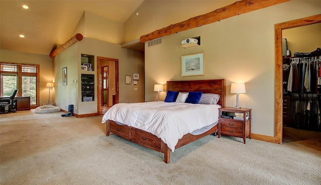 carpeted bedroom with a spacious closet, high vaulted ceiling, and a closet