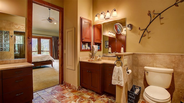 bathroom featuring ceiling fan, vanity, and toilet