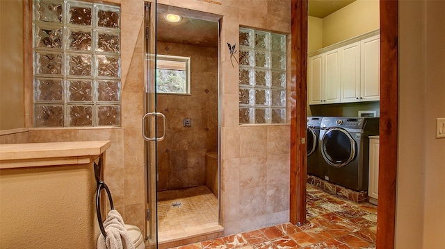 bathroom with washing machine and dryer and an enclosed shower