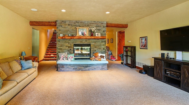 living room featuring carpet flooring and a stone fireplace