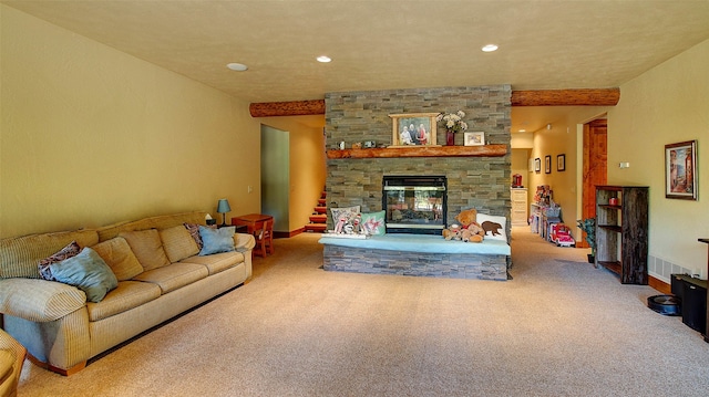 living room with a stone fireplace and carpet floors