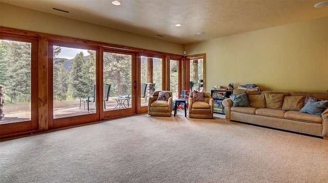 carpeted living room featuring a healthy amount of sunlight