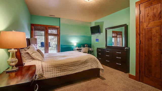 carpeted bedroom with french doors