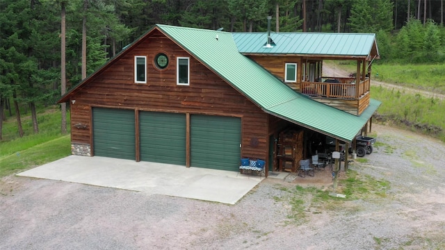 view of front of home featuring a balcony and a garage