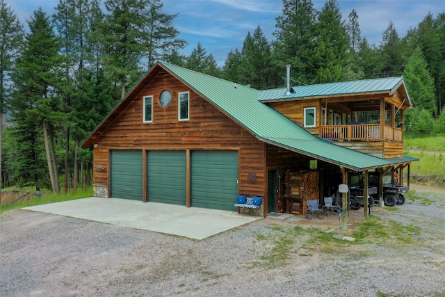 view of front of home featuring a balcony and a garage