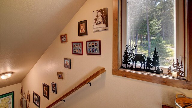 stairs featuring a textured ceiling