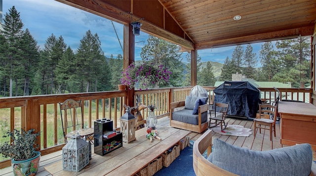 wooden deck featuring a grill