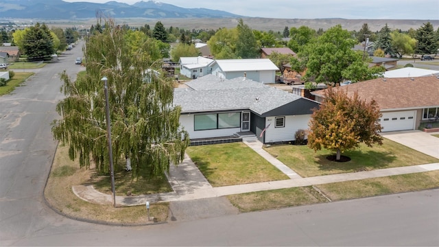 single story home featuring a garage and a front yard