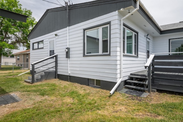 view of property exterior featuring a lawn