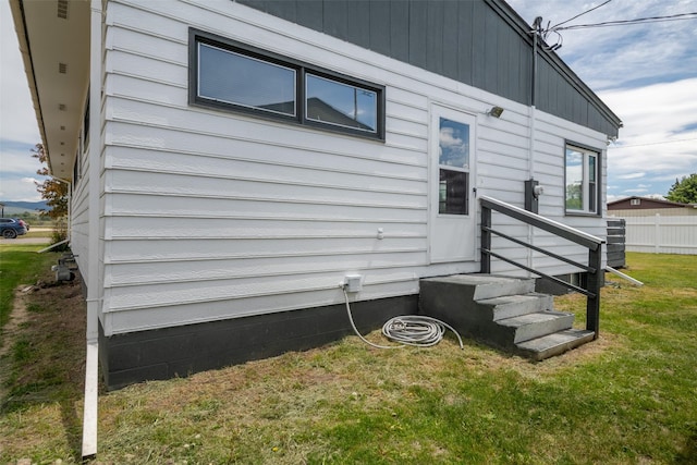 view of side of home with a lawn