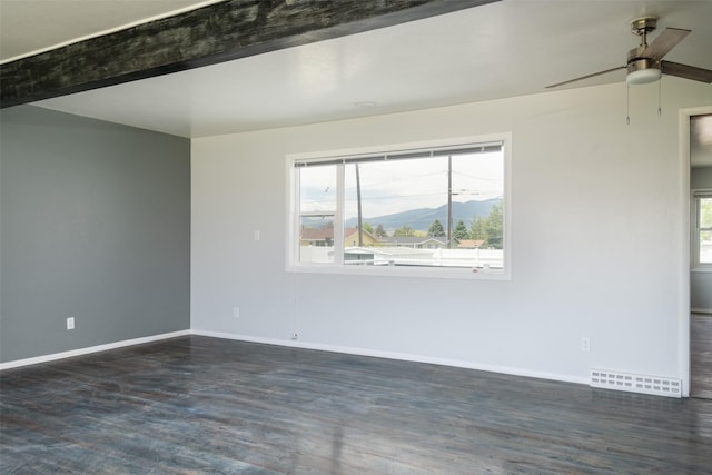 spare room with ceiling fan, beam ceiling, and a mountain view