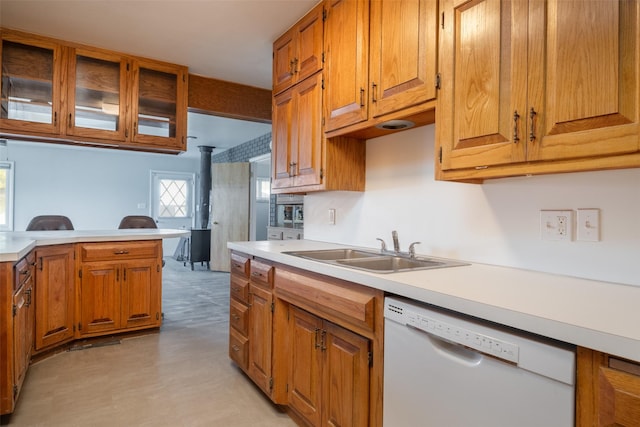 kitchen with dishwasher, sink, and kitchen peninsula