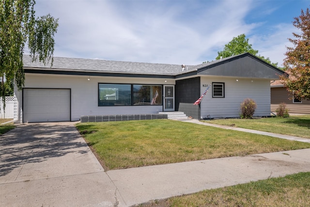 ranch-style home featuring a garage and a front yard