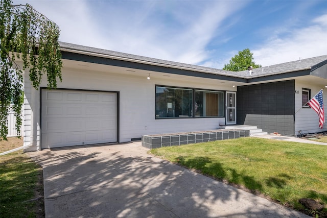 view of front of home with a garage and a front yard