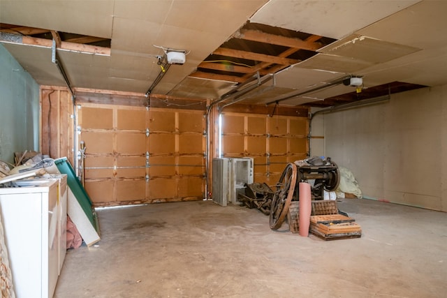 garage with a garage door opener and washer / dryer