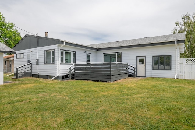 back of property featuring a yard and a deck