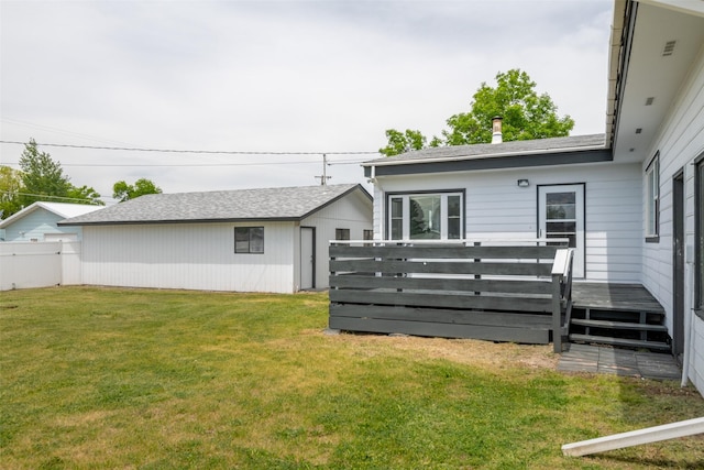 back of property featuring a yard and a deck