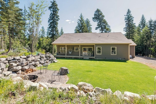 rear view of house featuring a lawn