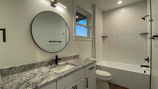 full bathroom featuring vanity, toilet, and tiled shower / bath