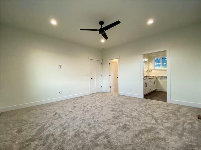 unfurnished bedroom featuring carpet, baseboards, and recessed lighting