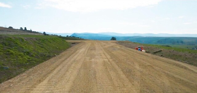 view of road featuring a mountain view and a rural view