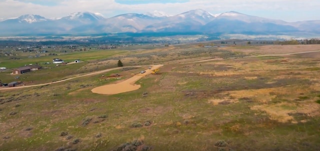 drone / aerial view with a mountain view and a rural view