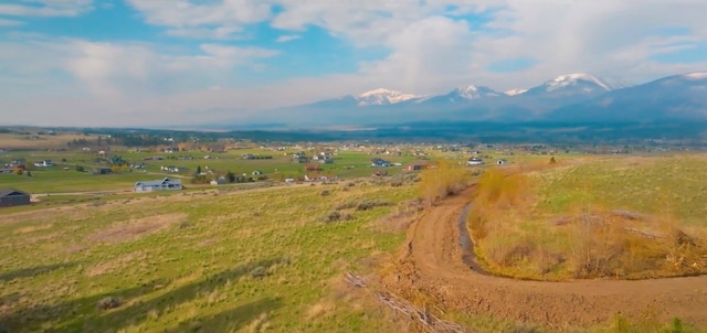 birds eye view of property featuring a mountain view and a rural view