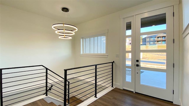 entryway with dark hardwood / wood-style flooring and a chandelier