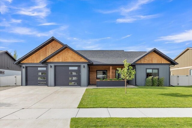 view of front of home featuring a front yard and a garage