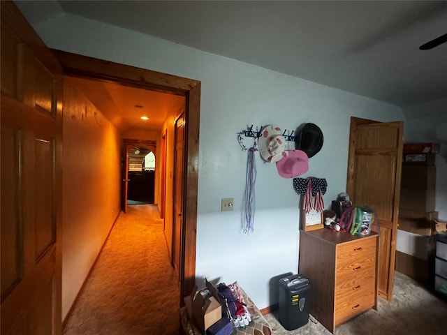 hallway featuring light colored carpet