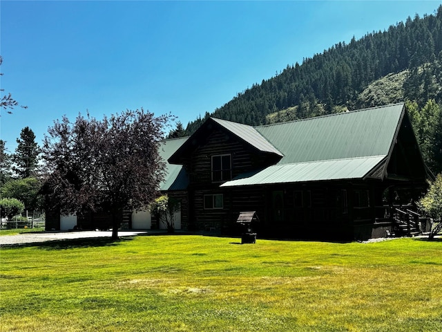 view of home's exterior featuring a yard and a mountain view