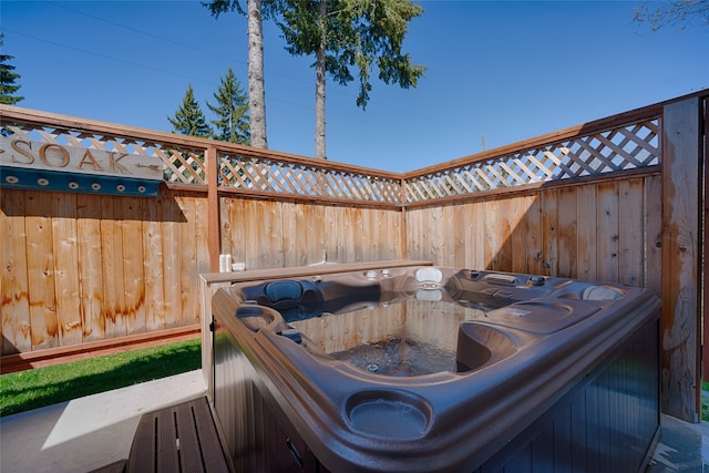 wooden deck featuring a hot tub